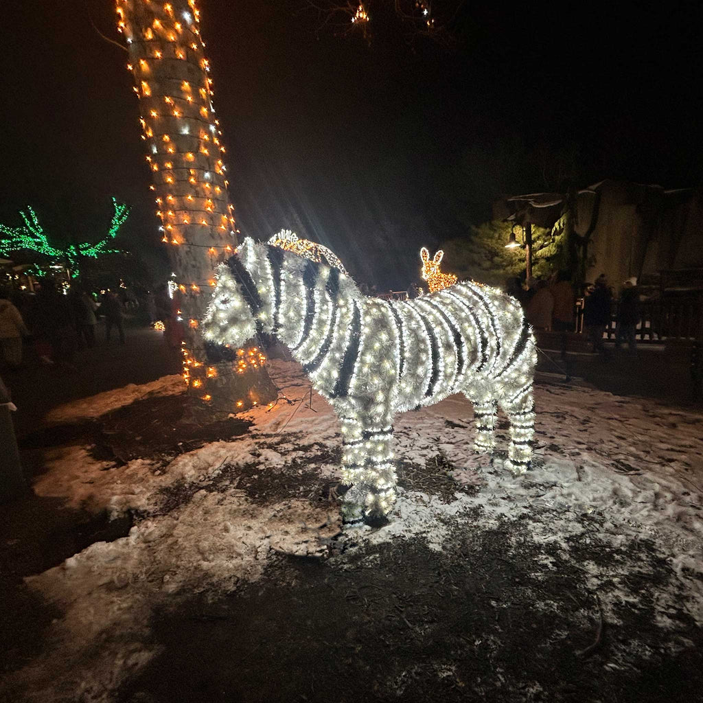 A zebra-shaped light display sculpture illuminated with pure white LED and outdoor textiles in black and white