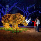large illuminated rhino display with glowing warm lights and a white horn